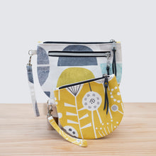 Load image into Gallery viewer, Two fabric bags with geometric patterns on a light wooden surface.
