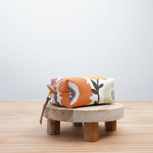 Load image into Gallery viewer, Floral-patterned pouch on a wooden stool with a light gray background Demi Boxy Bag Sewing Pattern PDF