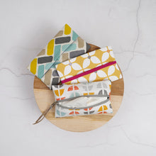 Load image into Gallery viewer, Three fabric pouches with different patterns on a wooden board Keya Tissue Pouch PDF Sewing Pattern