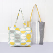 Load image into Gallery viewer, Two tote bags, one with a geometric pattern and the other with stripes, on a light background. Lily Tote Bag Sewing Pattern PDF