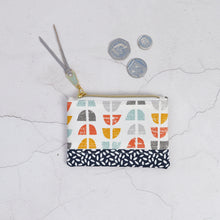 Load image into Gallery viewer, Small pouch with geometric pattern on a textured surface with coins. Luna Zipper Pouch Sewing Pattern PDF