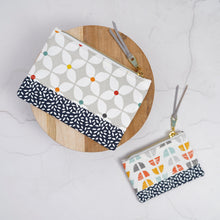Load image into Gallery viewer, Two fabric pouches with geometric patterns on a light gray background Luna Zipper Pouch Sewing Pattern PDF
