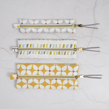Load image into Gallery viewer, Set of four patterned zipper pouches on a light gray background Mina Pencil Case Sewing Pattern PDF