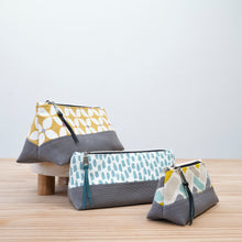 Load image into Gallery viewer, Three fabric pouches with zipper on a wooden surface and light gray background Nora Zipper Pouch Pattern PDF