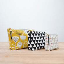 Load image into Gallery viewer, Three patterned pouches on a wooden surface with a white background Verity Zipper Pouch Sewing Pattern PDF