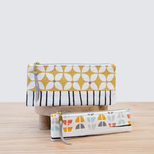 Load image into Gallery viewer, Two fabric pouches with geometric patterns on a wooden surface. pfd sewing pattern Molko Studios
