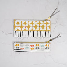 Load image into Gallery viewer, Three patterned pouches on a textured white surface
