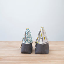Load image into Gallery viewer, Two fabric bags with patterned tops and gray bases on a wooden surface. Ayla Zipper Pouch Sewing Pattern PDF
