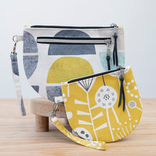 Load image into Gallery viewer, Two fabric bags with geometric patterns on a wooden surface. Brooke Wristlet Sewing Pattern PDF
