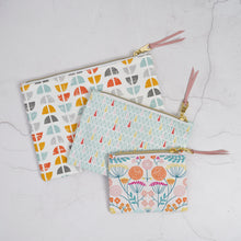 Load image into Gallery viewer, Three patterned pouches with zippers on a light gray surface Esmee Zipper Pouch Sewing Pattern PDF
