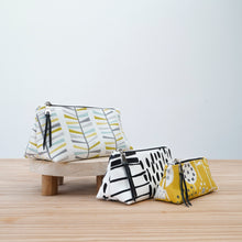 Load image into Gallery viewer, Three patterned pouches on a wooden surface with a light gray background Iris Zipper Pouch Pattern PDF
