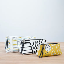 Load image into Gallery viewer, Three fabric pouches with different patterns on a wooden surface and light blue background Iris Zipper Pouch Pattern PDF
