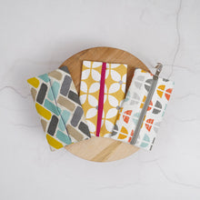 Load image into Gallery viewer, Three patterned bags on a wooden board with a white background Keya Tissue Pouch PDF Sewing Pattern
