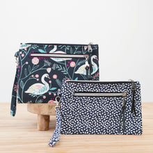 Load image into Gallery viewer, Two patterned handbags on a wooden surface with a light background Lena Wristlet Sewing Pattern PDF

