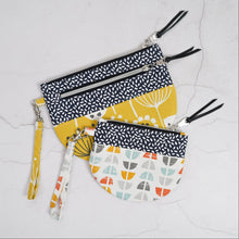 Load image into Gallery viewer, Set of three patterned pouches with zippers on a light gray background Lexi Wristlet Sewing Pattern PDF
