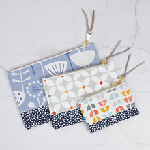 Load image into Gallery viewer, Three fabric pouches with floral and abstract patterns on a light gray background Luna Zipper Pouch Sewing Pattern PDF
