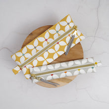 Load image into Gallery viewer, Two fabric pouches with gold zippers on a wooden board against a light gray background Mina Pencil Case Sewing Pattern PDF
