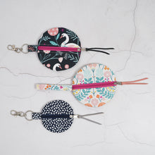 Load image into Gallery viewer, Round fabric pouches with floral and swan patterns on a textured white background. Naima Circle Coin Purse Sewing Pattern PDF
