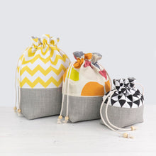 Load image into Gallery viewer, Three drawstring bags with different patterns on a light gray background pfd sewing pattern Molko Studios
