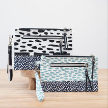 Load image into Gallery viewer, Three patterned handbags on a wooden surface with a light background Ria Wristlet Sewing Pattern PDF

