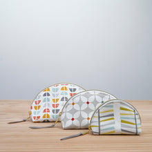 Load image into Gallery viewer, Three fabric pouches with geometric patterns on a wooden surface and light gray background Seren Dumpling Sewing Pattern PDF
