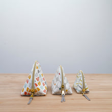Load image into Gallery viewer, Three pyramid-shaped pouches with zippers on a wooden surface and light gray background Seren Dumpling Sewing Pattern PDF
