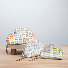 Load image into Gallery viewer, Three cosmetic bags with geometric patterns on a wooden surface and light gray background Seren Dumpling Sewing Pattern PDF
