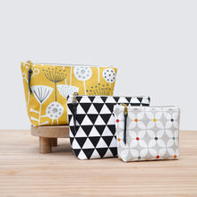 Load image into Gallery viewer, Three patterned pouches on a wooden surface with a light gray background pfd sewing pattern Molko Studios

